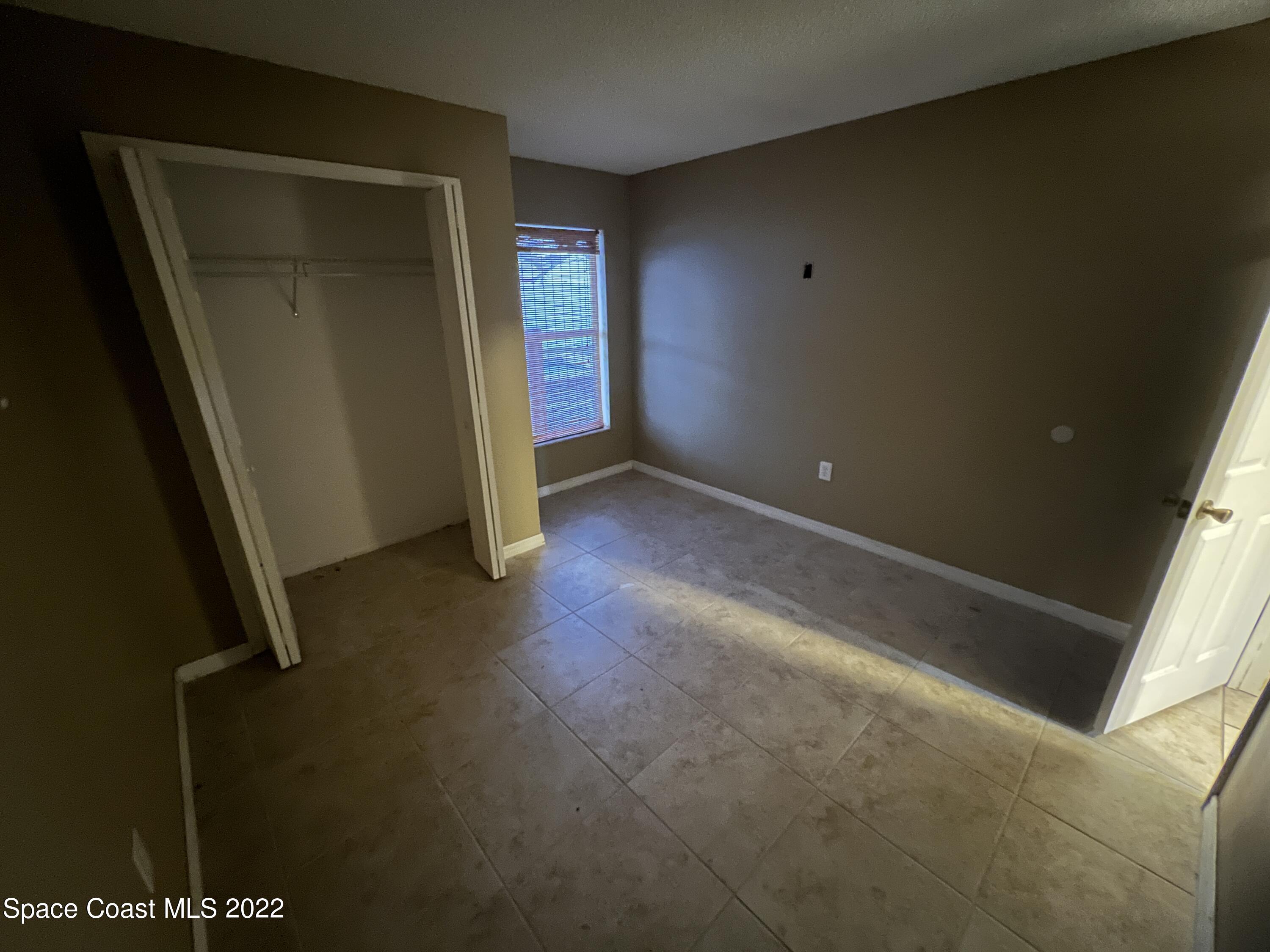 1873 Cleveland Street Northeast Palm Bay, FL 32905 - Photo 23 of 28 an empty room with windows