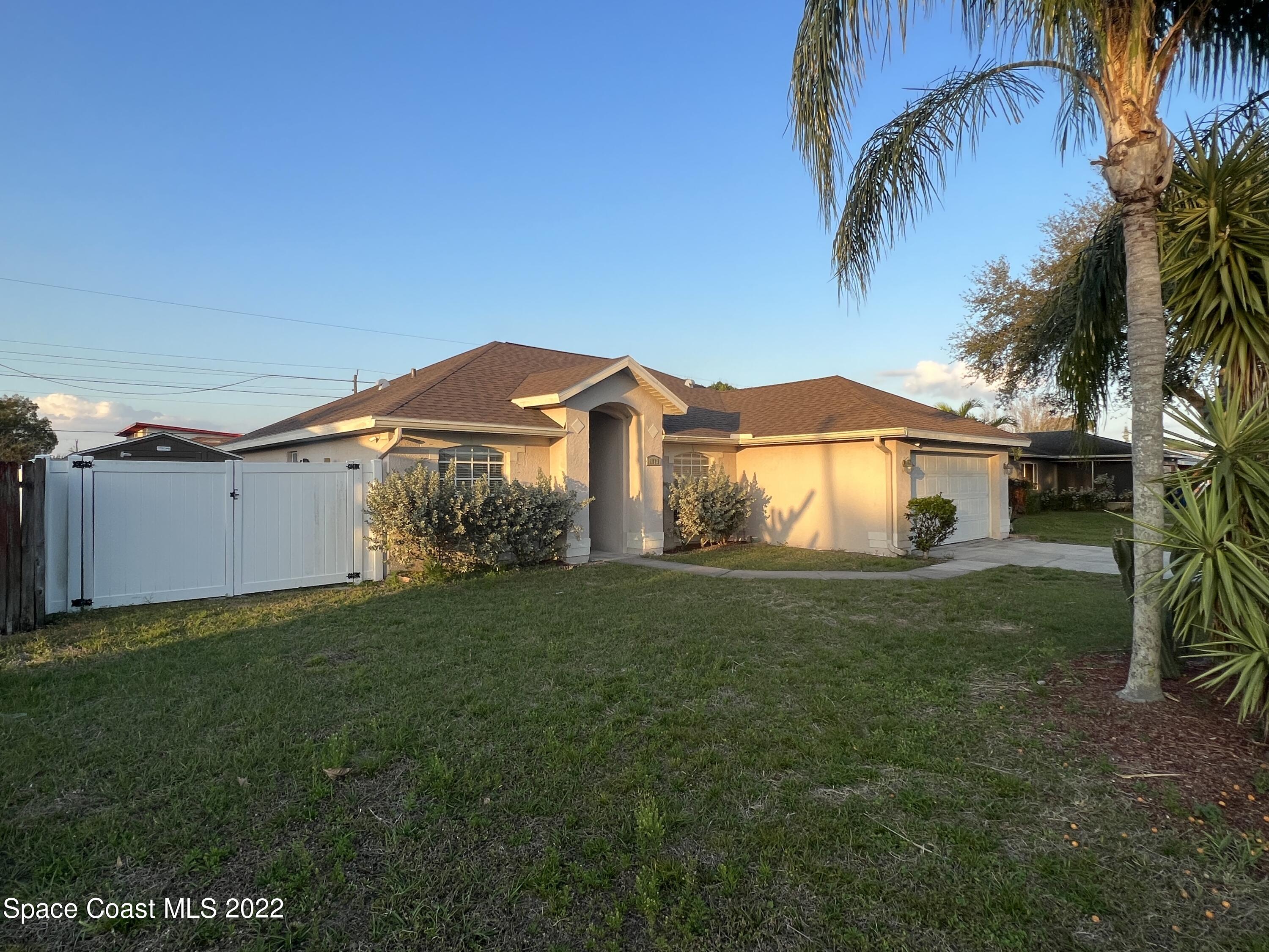 1873 Cleveland Street Northeast Palm Bay, FL 32905 - Photo 3 of 28 a view of a house with a yard and a large tree