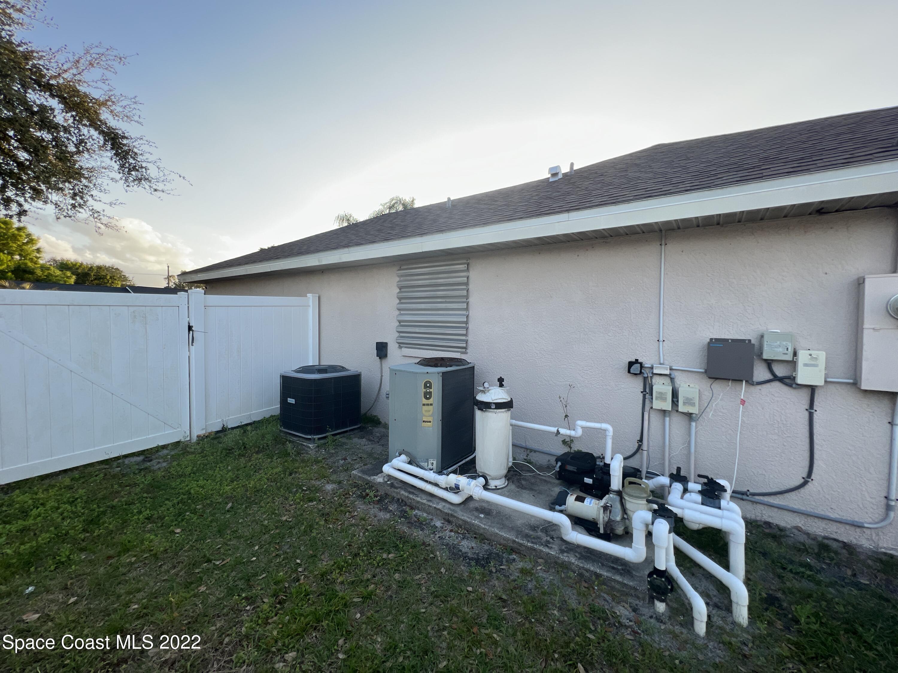 1873 Cleveland Street Northeast Palm Bay, FL 32905 - Photo 5 of 28 a backyard of a house with table and chairs