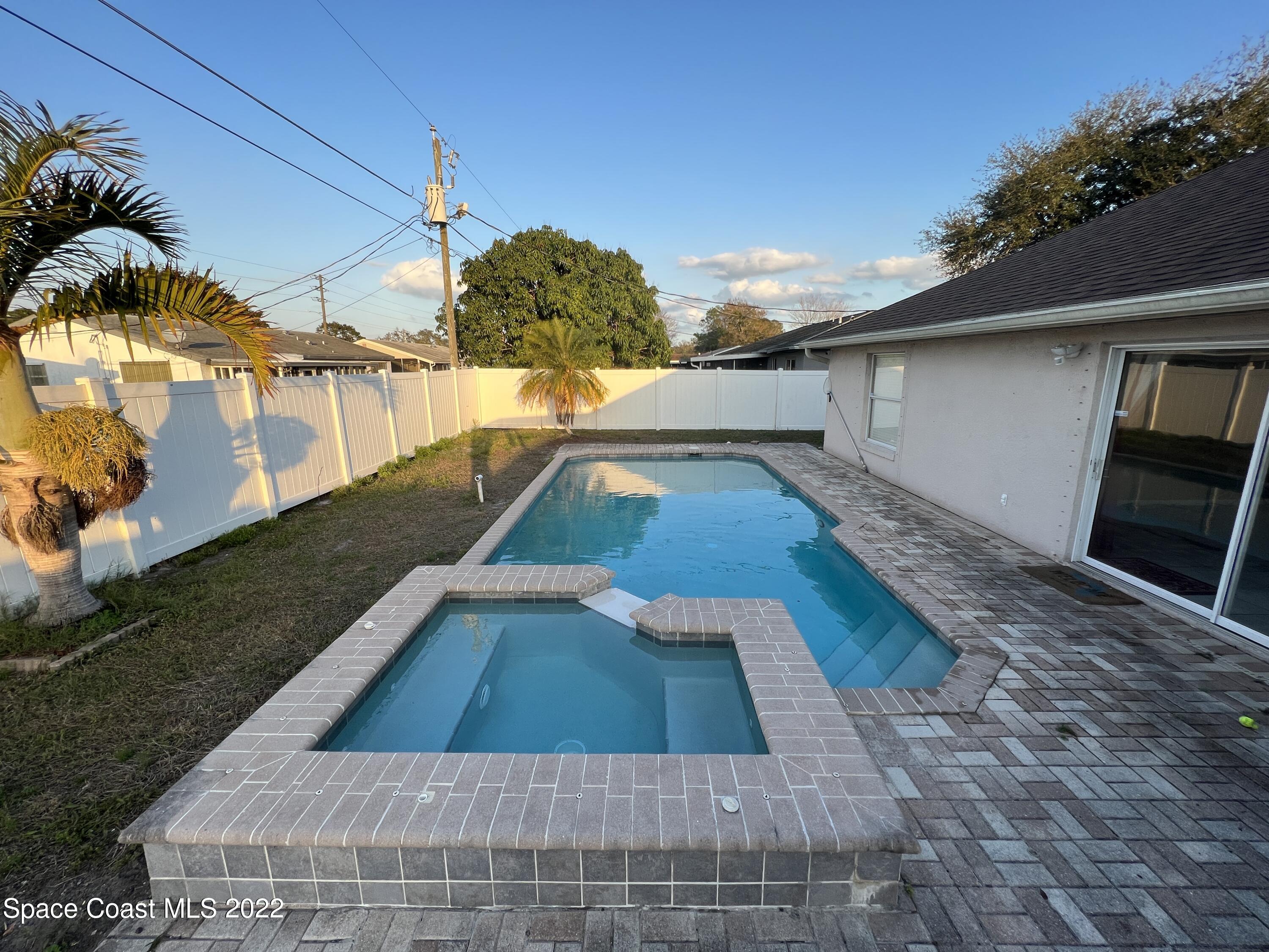 1873 Cleveland Street Northeast Palm Bay, FL 32905 - Photo 8 of 28 a view of a swimming pool with a patio