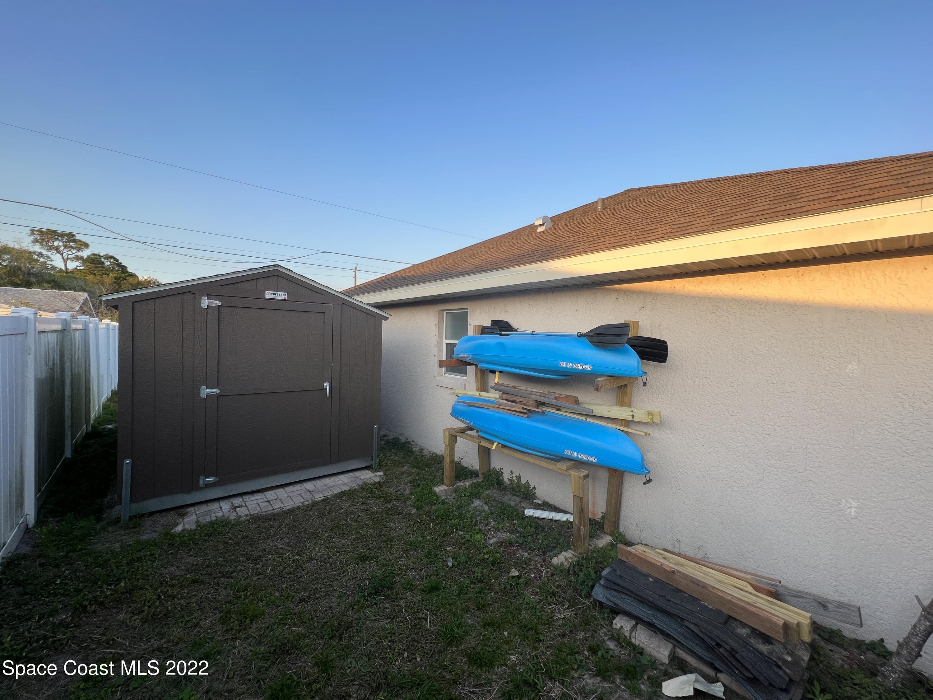 1873 Cleveland Street Northeast Palm Bay, FL 32905 - Photo 9 of 28 a backyard of a house with table and chairs