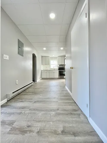 a kitchen with a refrigerator and a stove top oven