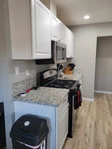 a kitchen with stainless steel appliances a refrigerator sink and cabinets