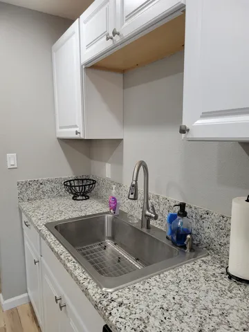 a kitchen with a stove a sink and a microwave