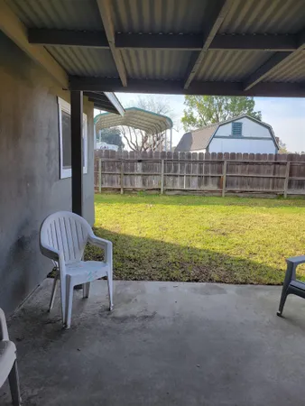 a view of a two chairs in the patio