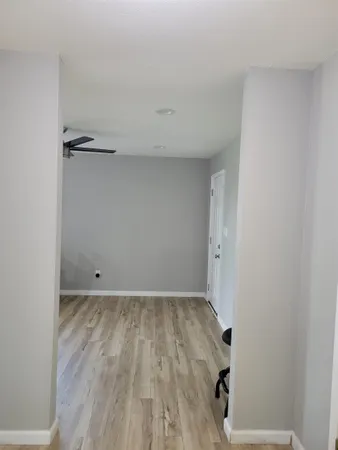a view of empty room with wooden floor