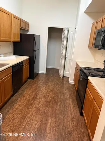 a kitchen with stainless steel appliances granite countertop a refrigerator a stove and a sink