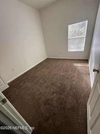 a view of an empty room and a window