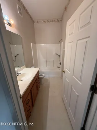 a bathroom with a sink a toilet a mirror and vanity