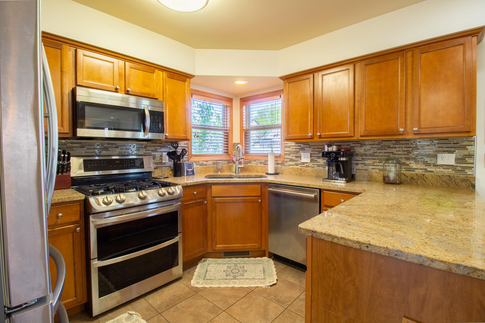 2550 Honelee Court Valparaiso, IN 46385 - Photo 12 of 37 a kitchen with a stove a sink and a microwave