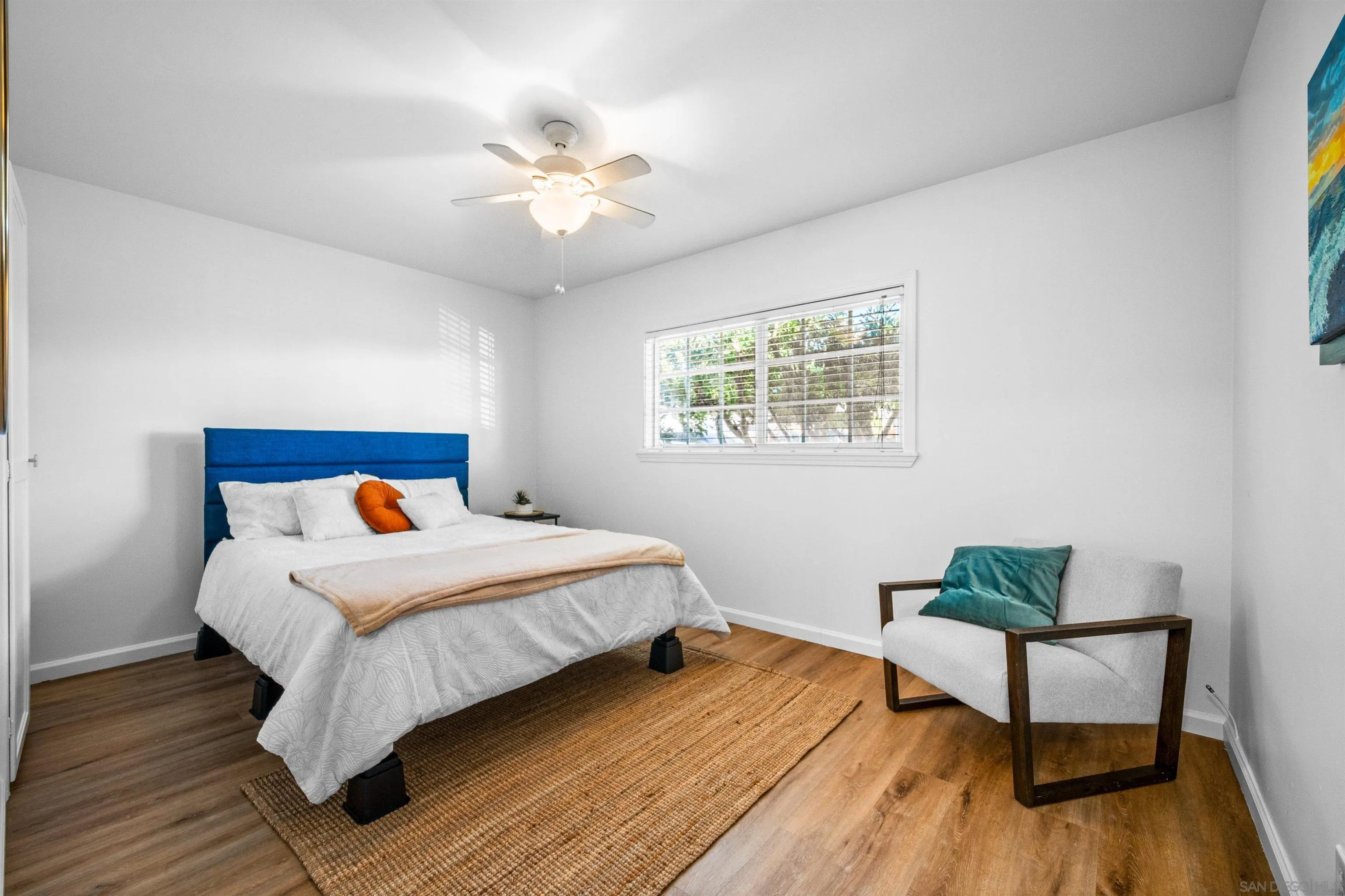 604 Monterey Drive Oceanside, CA 92058 - Photo 12 of 27 a bedroom with a bed and wooden floor