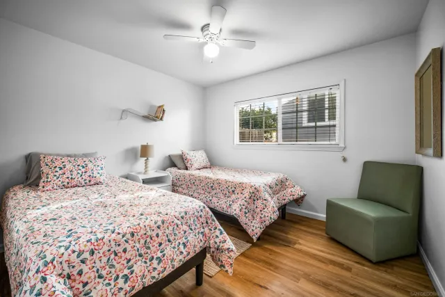 a bedroom with two beds and a couch