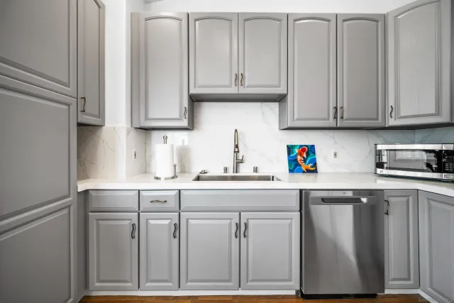 a kitchen with granite countertop cabinets and white appliances
