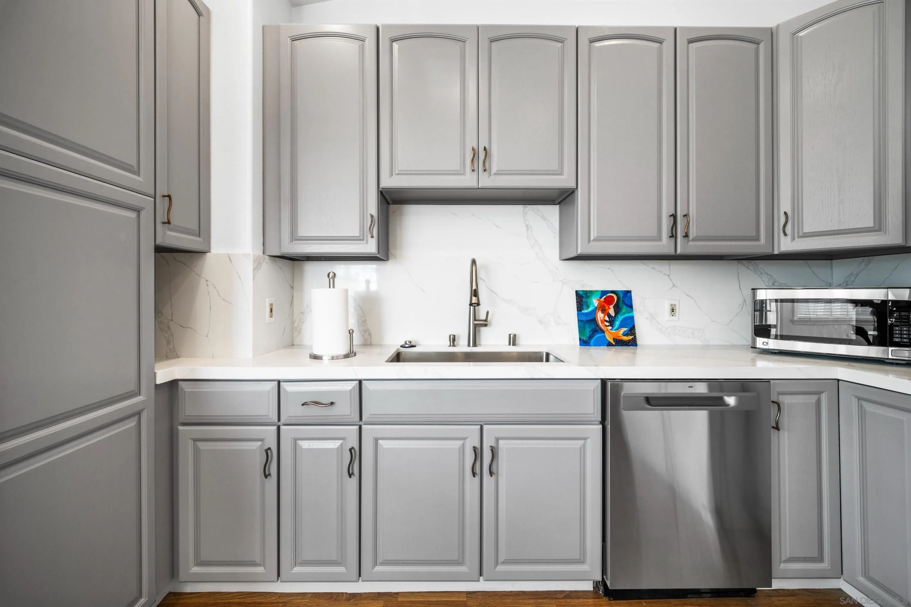 604 Monterey Drive Oceanside, CA 92058 - Photo 20 of 27 a kitchen with granite countertop cabinets and white appliances