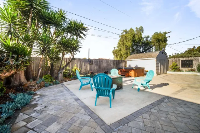a view of a backyard with plants and a patio
