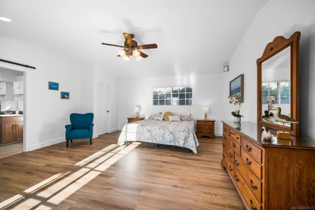 a bedroom with furniture and a wooden floor