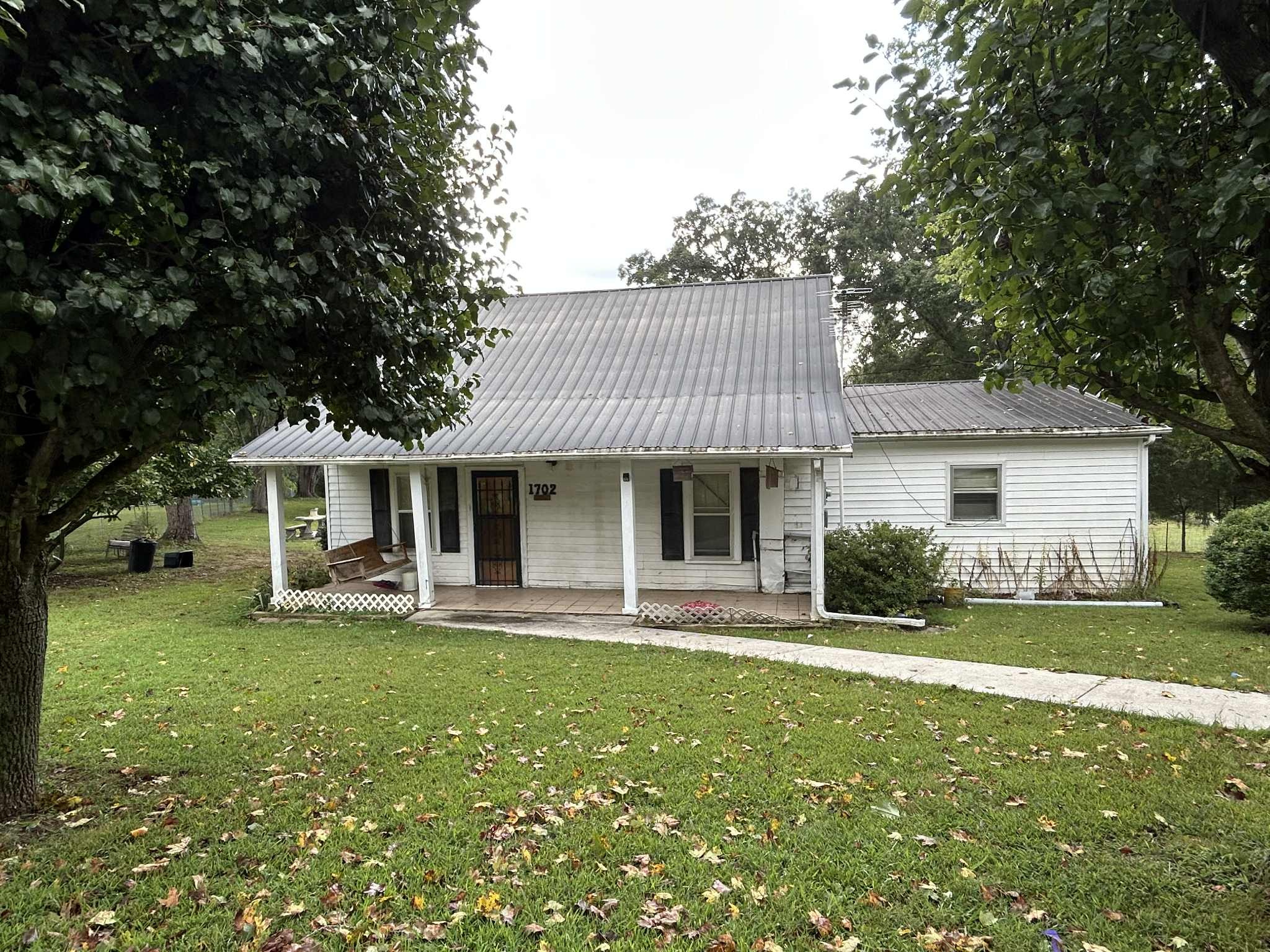 1702 Johnson Chapel Road Sparta, TN 38583 - Photo 1 of 9 a front view of a house with a yard