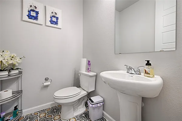 a bathroom with a sink mirror and toilet