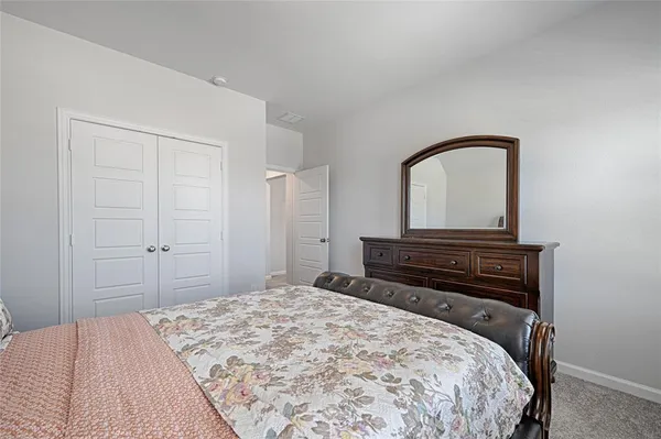 a bedroom with a bed and a dresser