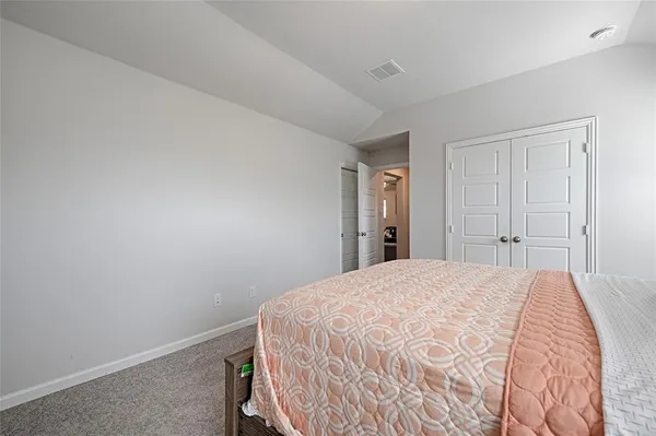 a bedroom with a bed and a cabinet
