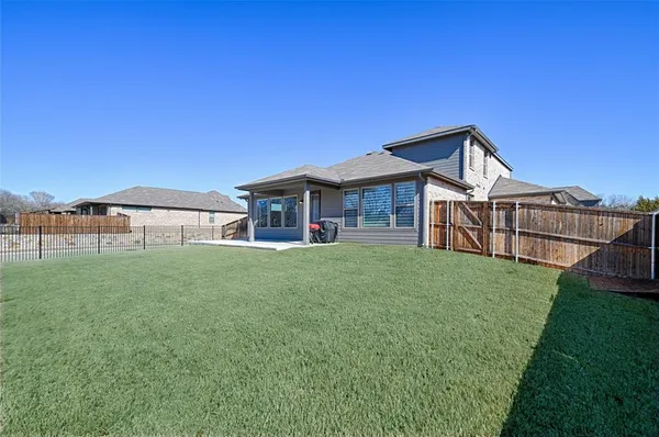 a front view of a house with yard porch and furniture