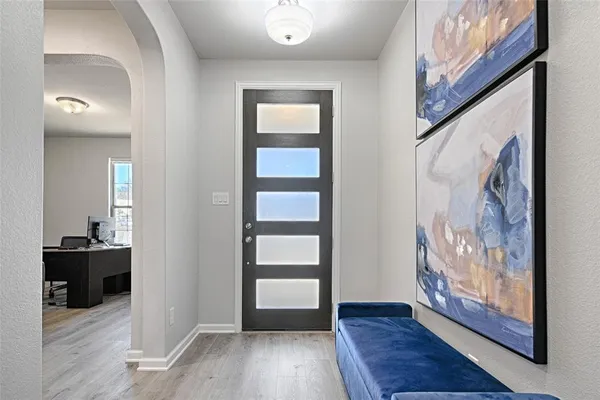 a view of an entryway with wooden floor