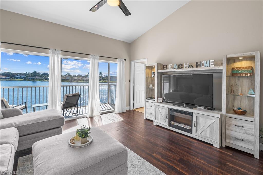541 Windsor Square Naples, FL 34104 - Photo 13 of 25 a living room with furniture a flat screen tv and a floor to ceiling window