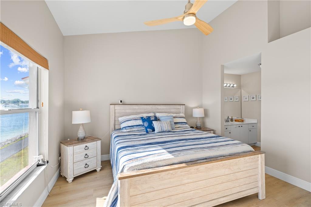 541 Windsor Square Naples, FL 34104 - Photo 14 of 25 a bedroom with a bed and a large window