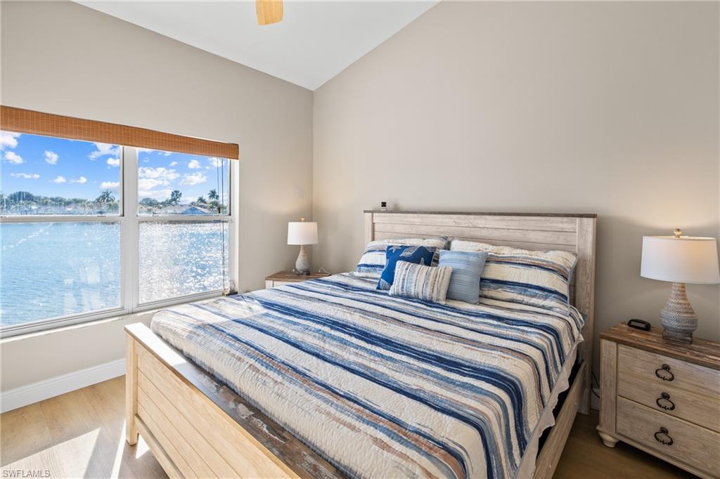 541 Windsor Square Naples, FL 34104 - Photo 15 of 25 a bedroom with a bed and a large window