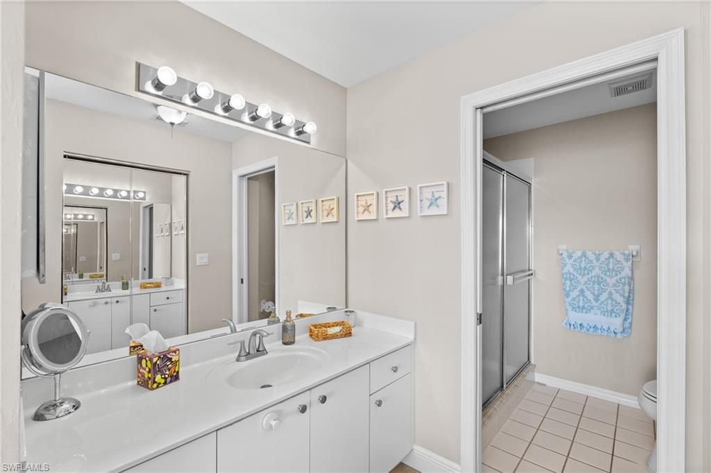 541 Windsor Square Naples, FL 34104 - Photo 17 of 25 a bathroom with a sink and a mirror