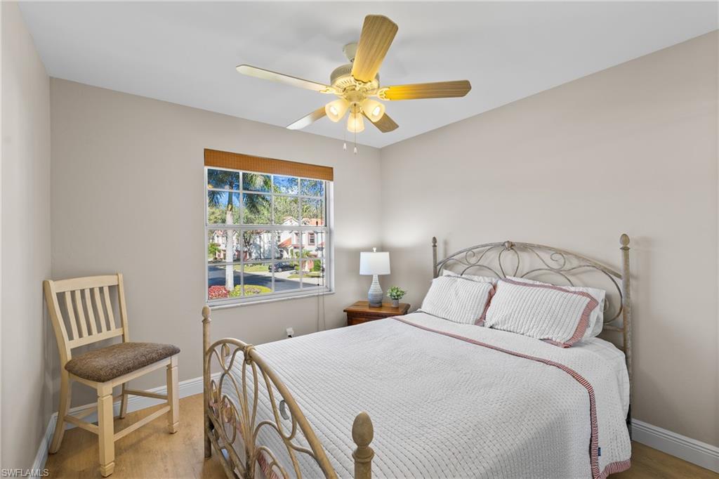 541 Windsor Square Naples, FL 34104 - Photo 19 of 25 a bedroom with a bed and a window