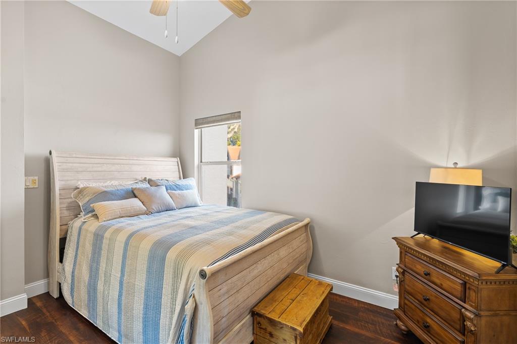 541 Windsor Square Naples, FL 34104 - Photo 23 of 25 a bedroom with a bed and a television