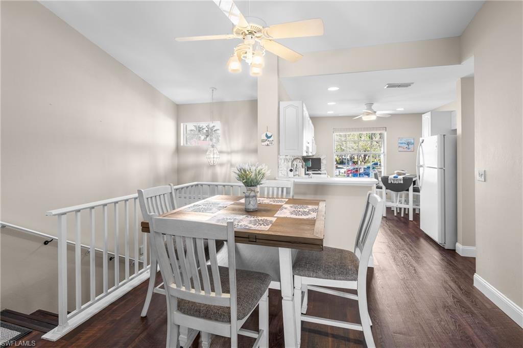 541 Windsor Square Naples, FL 34104 - Photo 4 of 25 a view of a dining room and livingroom with furniture wooden floor a chandelier