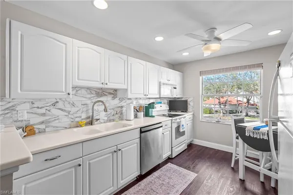a kitchen with a sink cabinets and window