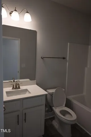 a view of an empty room with windows and closet