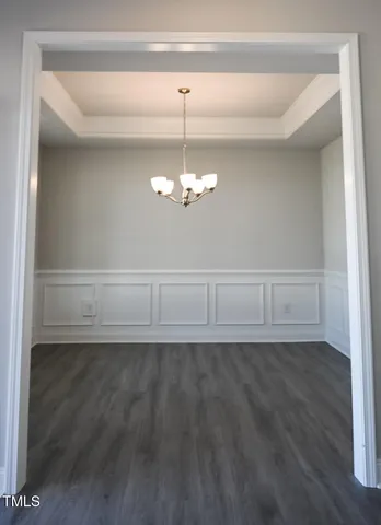 a kitchen with granite countertop a stove a sink and a wooden floor