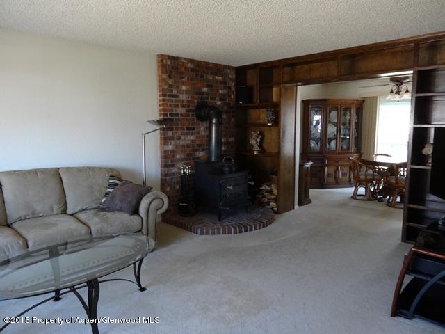 960 Cedar Drive Rifle, CO 81650 - Photo 4 of 27 a living room with furniture and a floor to ceiling window