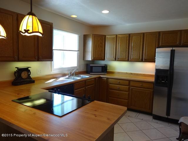 960 Cedar Drive Rifle, CO 81650 - Photo 6 of 27 a kitchen with stainless steel appliances granite countertop a sink stove and refrigerator