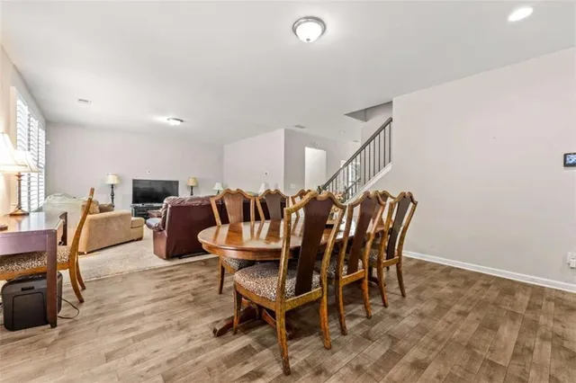a dining room with furniture and wooden floor