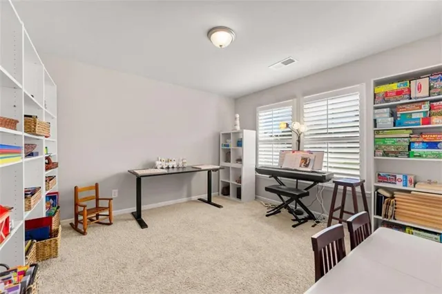 a view of a workspace with furniture and a window