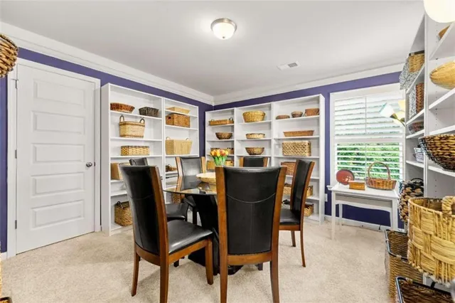a view of a dining room with furniture and a window