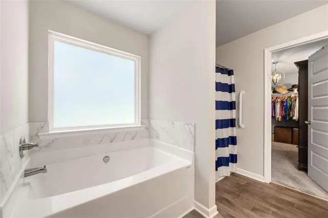 a bathroom with a bathtub and a shower