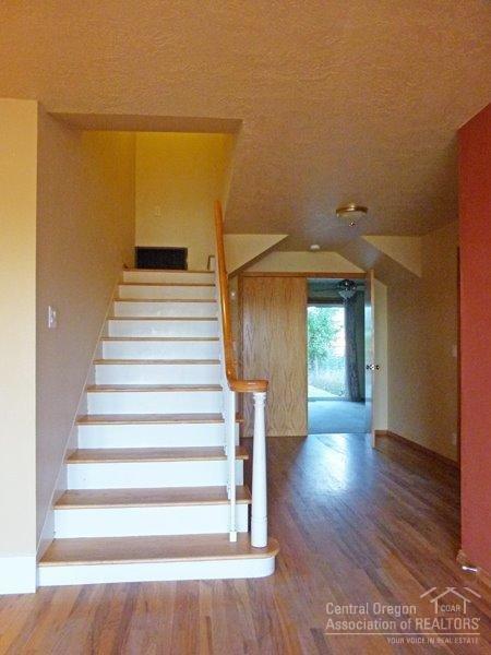 13220 Southwest Houston Lake Road Powell Butte, OR 97753 - Photo 18 of 24 Stairs leading up to 3 large bedrooms ab