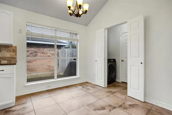 a view of a room with a large mirror and furniture