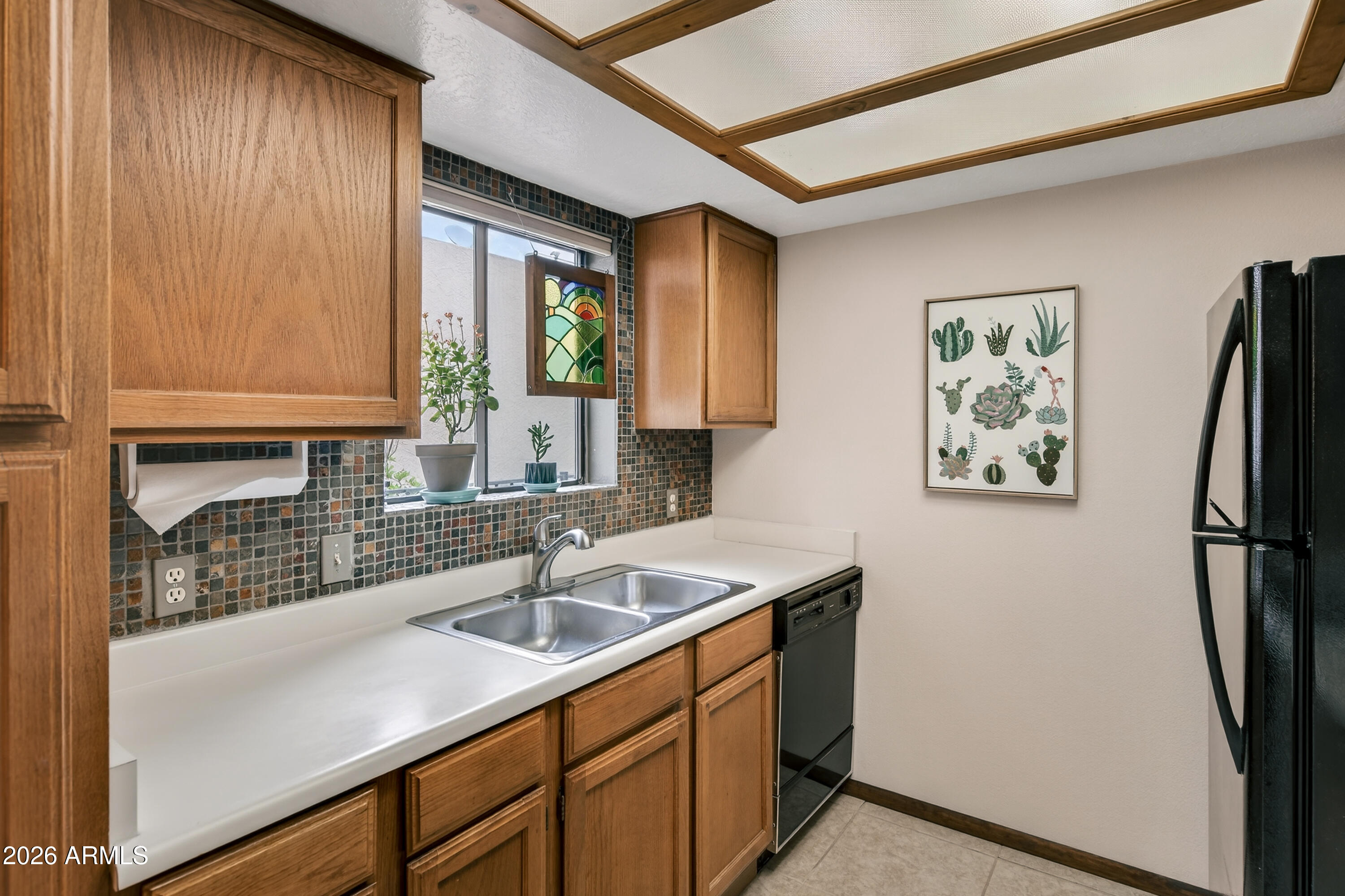 65 Verde Valley School Road, Unit B14 Sedona, AZ 86351 - Photo 5 of 25 a kitchen with a sink a refrigerator and cabinets