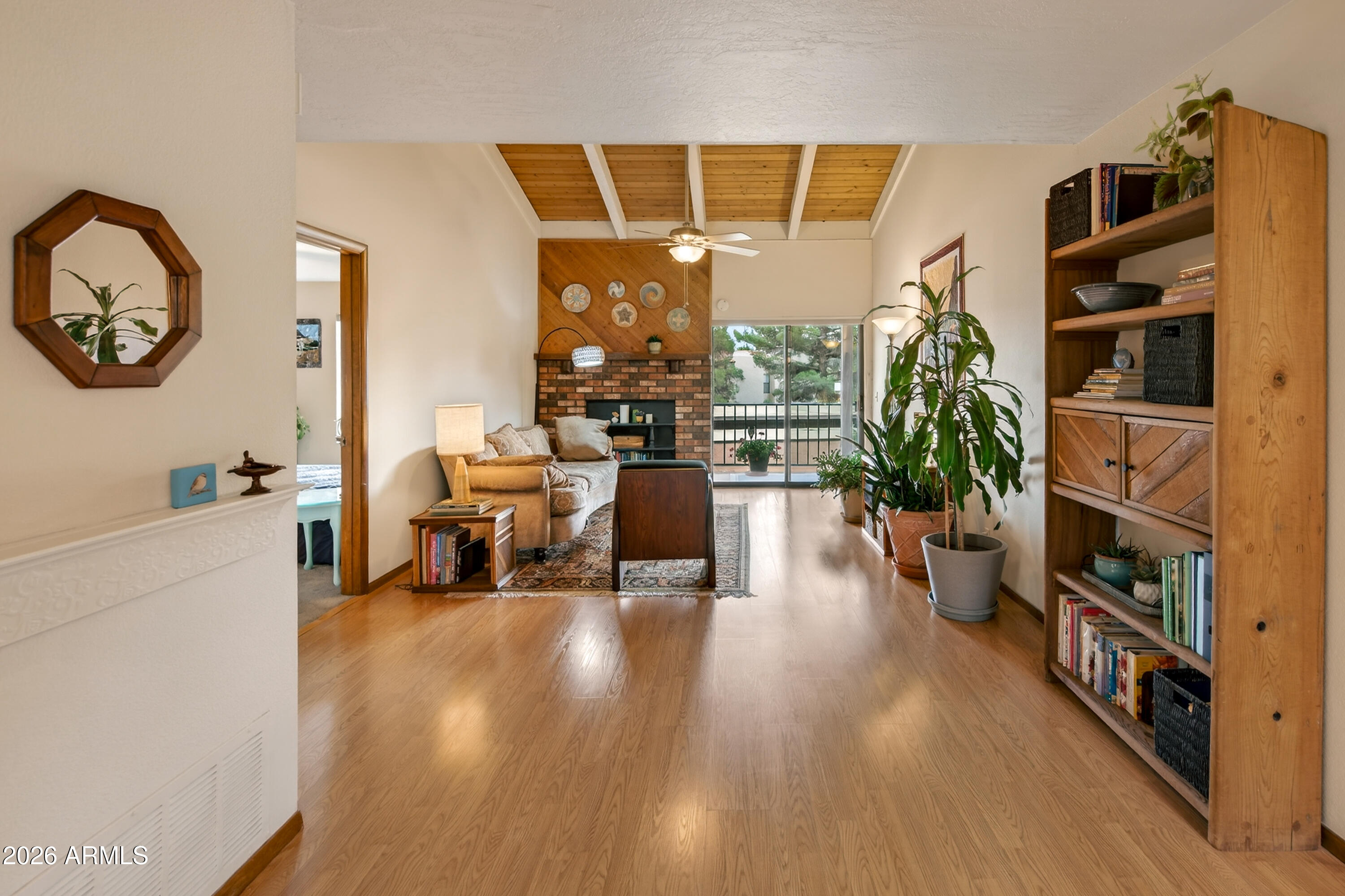 65 Verde Valley School Road, Unit B14 Sedona, AZ 86351 - Photo 7 of 25 a living room with furniture and a book shelf