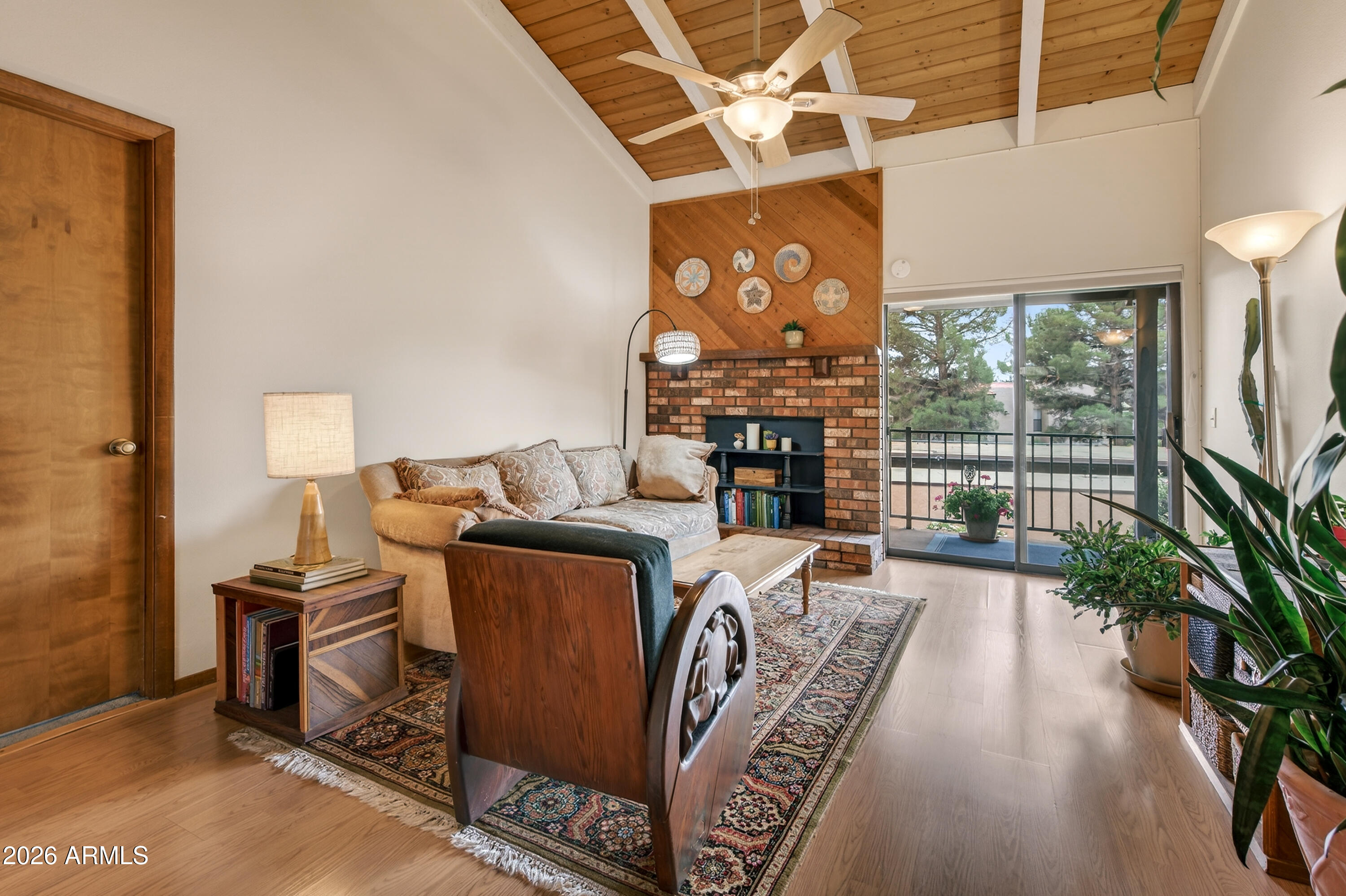 65 Verde Valley School Road, Unit B14 Sedona, AZ 86351 - Photo 8 of 25 a living room with furniture a flat screen tv and a floor to ceiling window