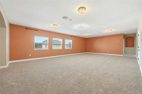 a bedroom with a large bed and a couch