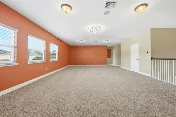 a view of a livingroom with an empty space and a window