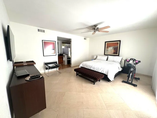 a bedroom with a bed and a chair